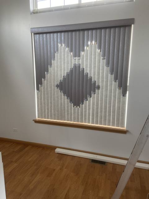 Grey and white diamond-pattern vertical blinds